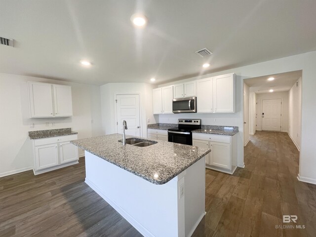 kitchen featuring stainless steel appliances, dark wood-type flooring, sink, a center island with sink, and white cabinets