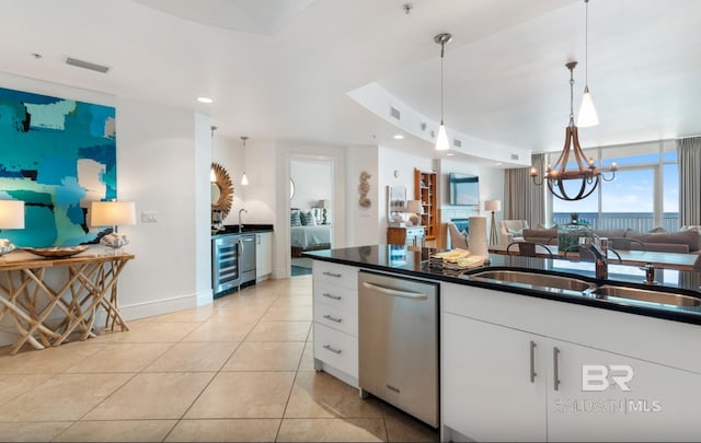 26302 Perdido Beach Blvd Unit D708, Orange Beach, AL 36561 - kitchen with dishwasher, beverage cooler, dark countertops, open floor plan, and white cabinetry