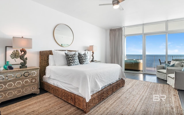 26302 Perdido Beach Blvd Unit D708, Orange Beach, AL 36561 - bedroom with access to exterior, wood finished floors, a water view, a ceiling fan, and floor to ceiling windows