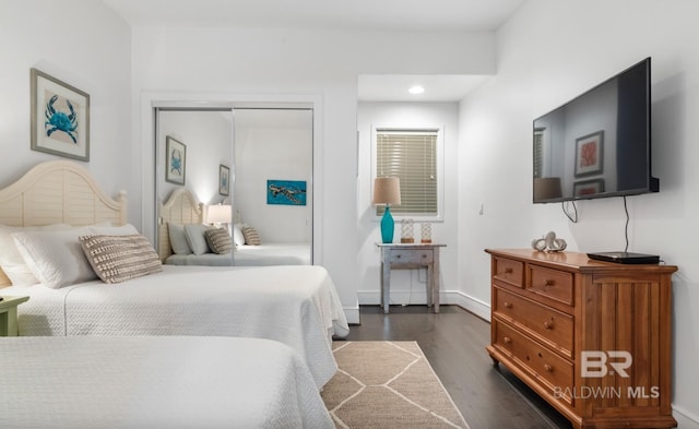 26302 Perdido Beach Blvd Unit D708, Orange Beach, AL 36561 - bedroom with dark wood finished floors, a closet, and recessed lighting