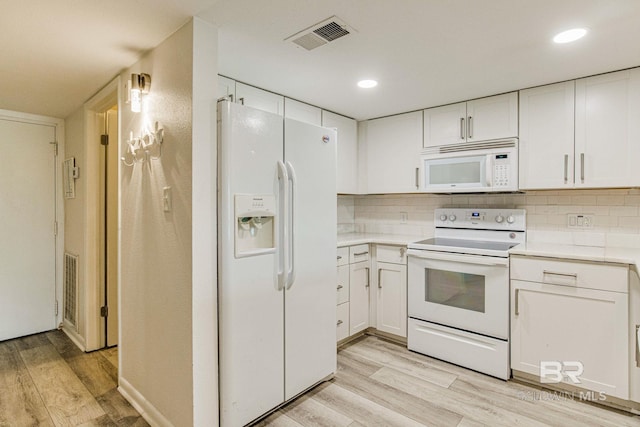 kitchen featuring white cabinetry, white appliances, tasteful backsplash, and light wood-type flooring