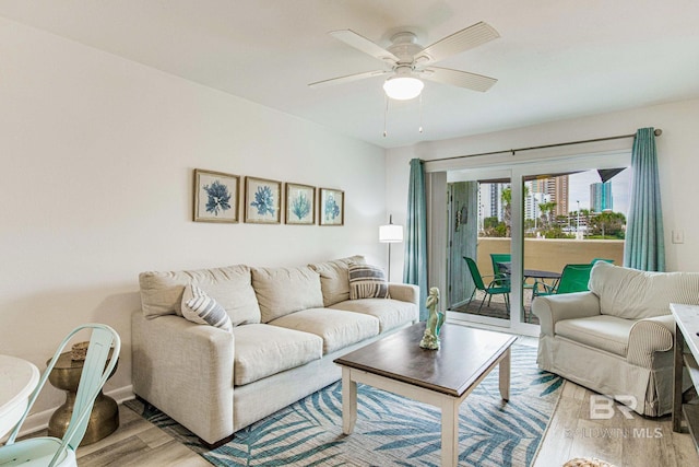 living room featuring ceiling fan and light wood-type flooring