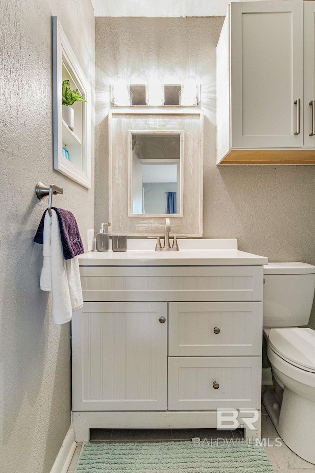 bathroom featuring vanity and toilet