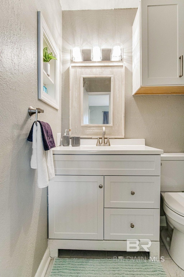 bathroom with vanity and toilet