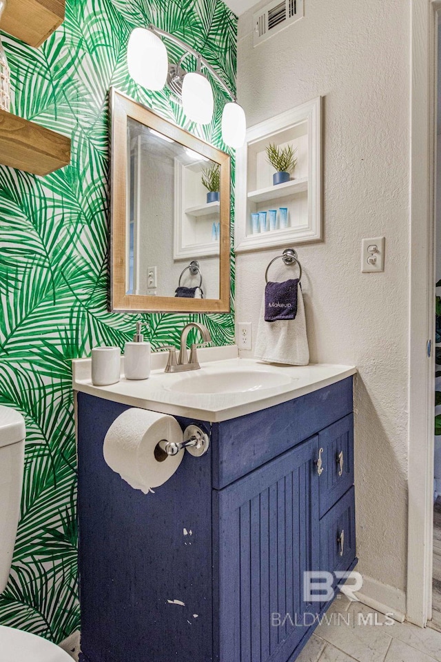 bathroom with vanity and toilet