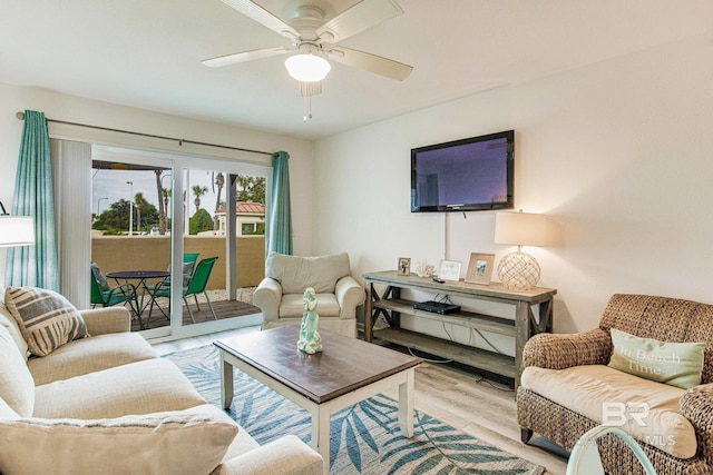 living room with ceiling fan and light wood-type flooring