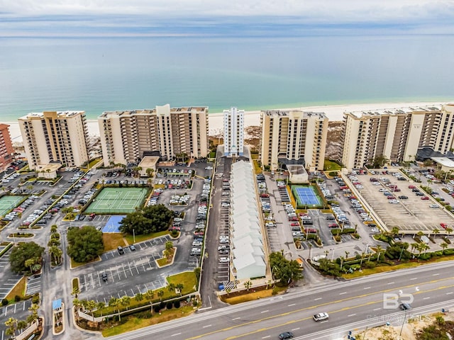 drone / aerial view featuring a water view and a beach view