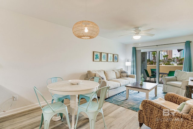 living room with ceiling fan and light wood-type flooring