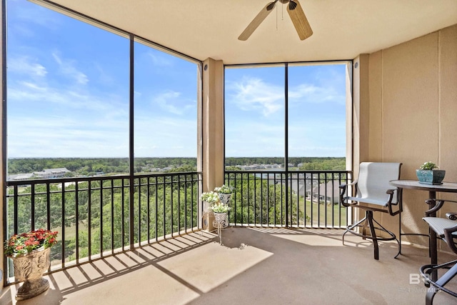 sunroom / solarium with carpet floors, plenty of natural light, and expansive windows