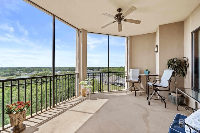 sunroom with carpet and floor to ceiling windows