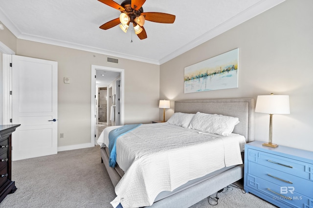 bedroom featuring crown molding, visible vents, ensuite bathroom, baseboards, and carpet