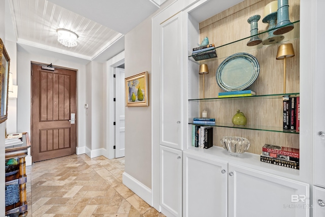 foyer entrance with baseboards and stone finish flooring
