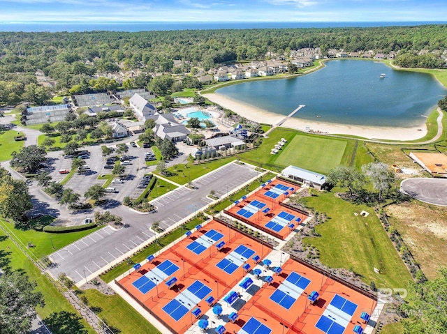 birds eye view of property with a water view and a view of trees