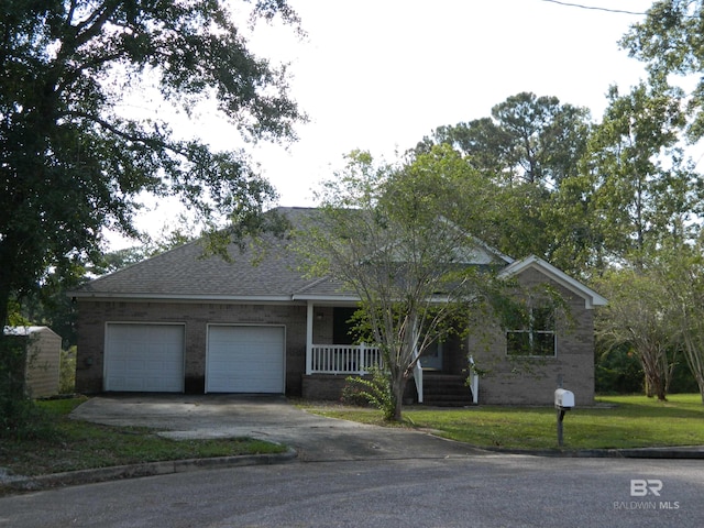 ranch-style house featuring a garage, a front yard, and covered porch