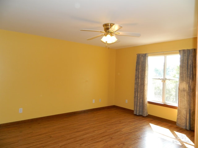 unfurnished room with hardwood / wood-style floors and ceiling fan