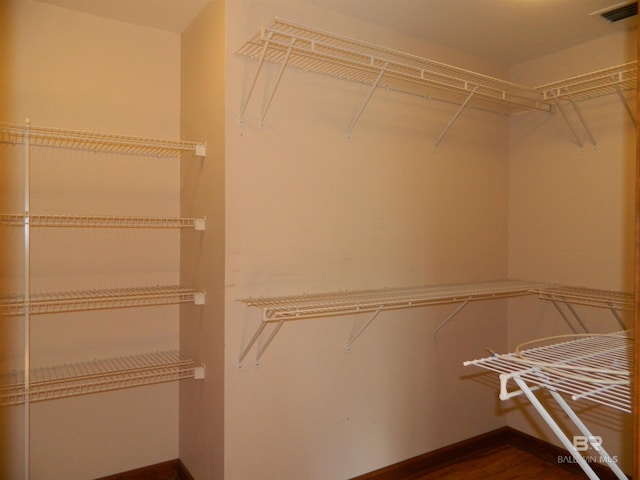 spacious closet featuring hardwood / wood-style flooring