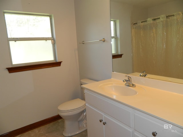 bathroom with tile patterned floors, vanity, and toilet