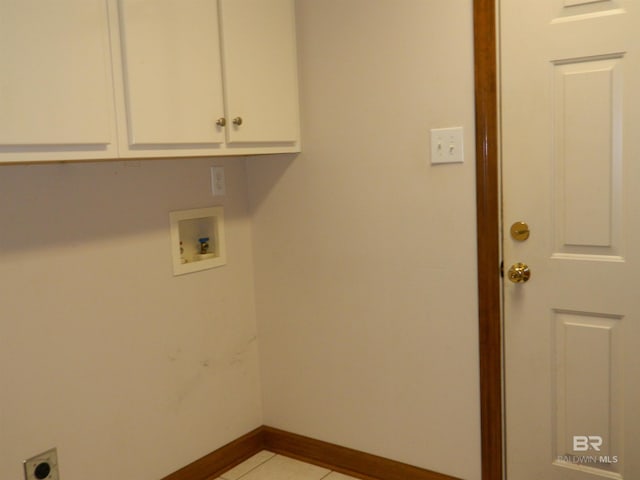 washroom with washer hookup, cabinets, light tile patterned floors, and electric dryer hookup