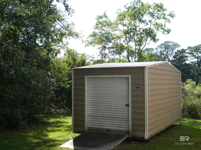 view of outdoor structure featuring a lawn