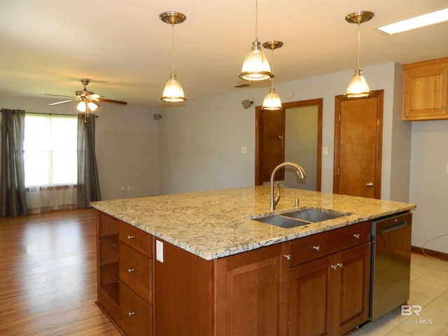 kitchen with pendant lighting, sink, a center island with sink, dishwasher, and light hardwood / wood-style floors