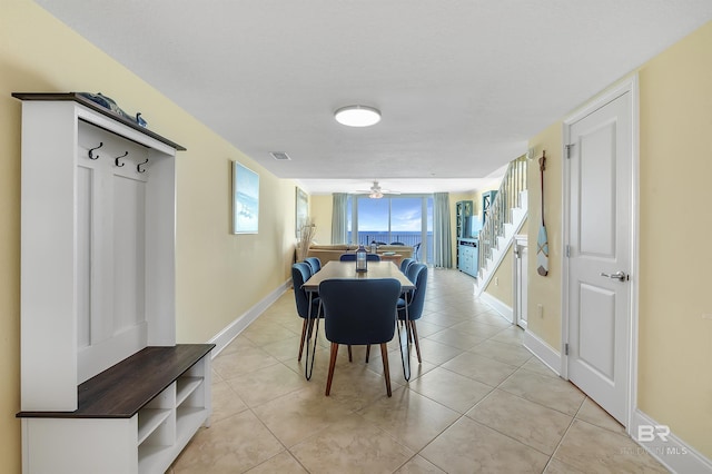 dining room featuring visible vents, baseboards, a ceiling fan, and light tile patterned flooring