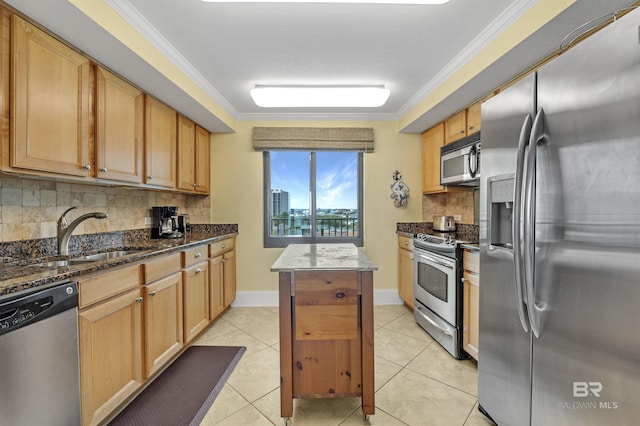 kitchen featuring crown molding, stainless steel appliances, light tile patterned flooring, a sink, and dark stone counters