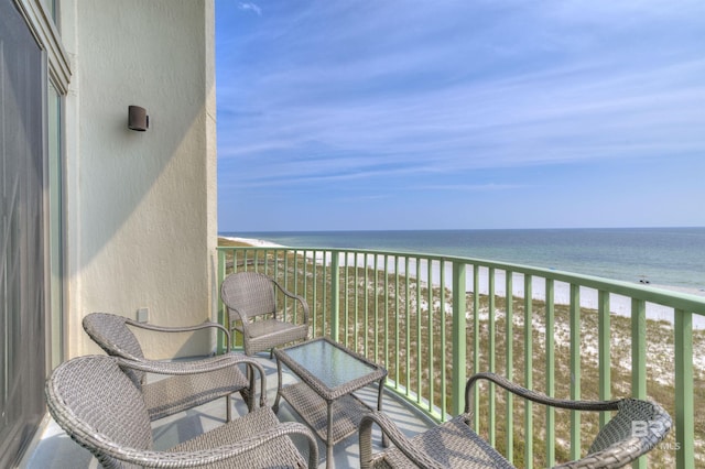 balcony featuring a water view and a beach view