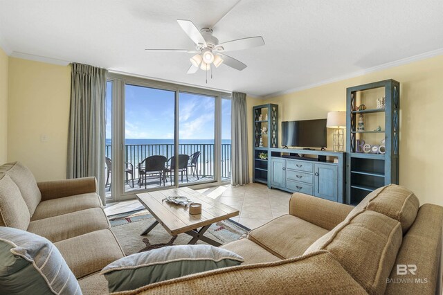 living area featuring light tile patterned floors, ceiling fan, floor to ceiling windows, and crown molding