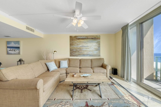 living area featuring ornamental molding, visible vents, and ceiling fan