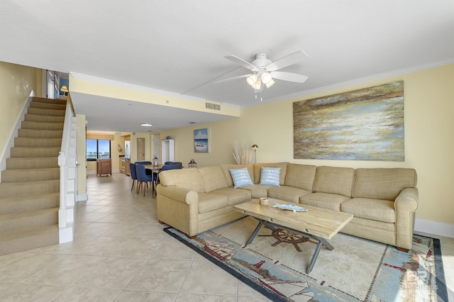 living room featuring stairs, visible vents, crown molding, and light tile patterned floors