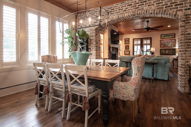 dining space featuring wooden ceiling, brick wall, dark hardwood / wood-style floors, and a fireplace