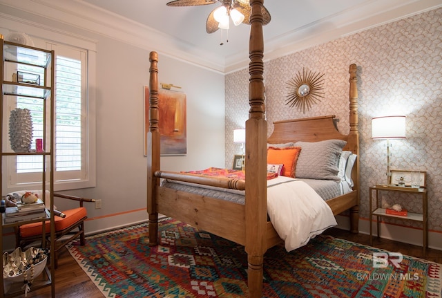 bedroom featuring ceiling fan, ornamental molding, and dark hardwood / wood-style floors