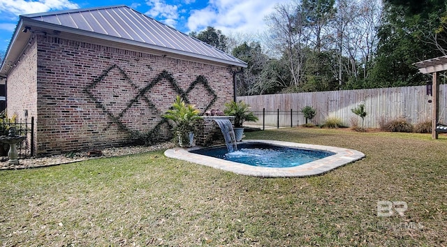 view of swimming pool featuring a yard and pool water feature