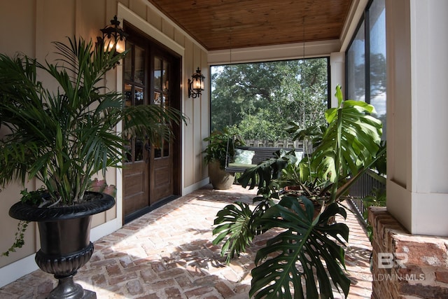 sunroom featuring wood ceiling