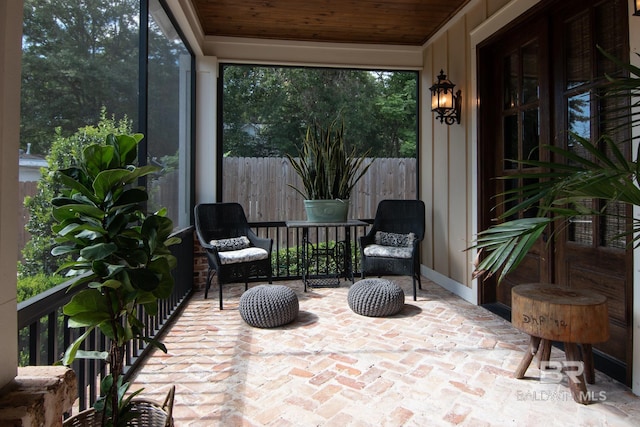 sunroom / solarium featuring wood ceiling