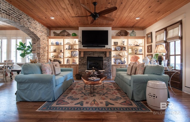 living room featuring wood ceiling, a wealth of natural light, a fireplace, and dark hardwood / wood-style flooring