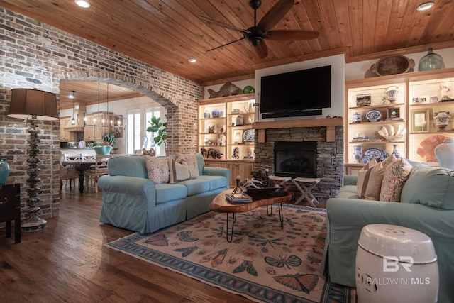 living room with brick wall, hardwood / wood-style floors, wood ceiling, a fireplace, and ceiling fan