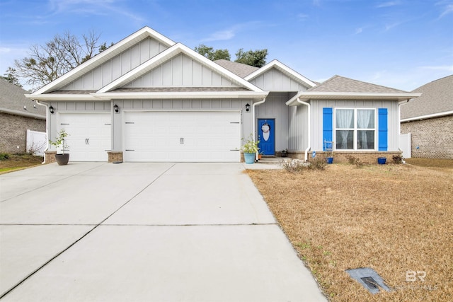 view of front of property featuring a garage, driveway, board and batten siding, and roof with shingles