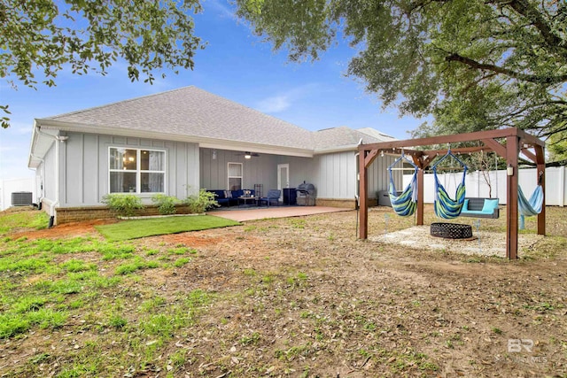 rear view of property with a shingled roof, a patio, fence private yard, central air condition unit, and board and batten siding