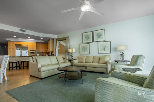 living room featuring a ceiling fan, recessed lighting, visible vents, and light tile patterned floors