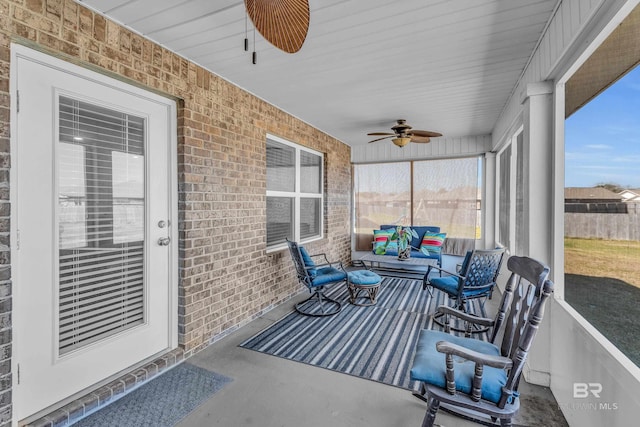 sunroom featuring ceiling fan