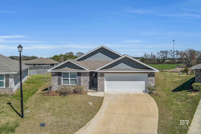 view of front of property with driveway, an attached garage, fence, a front lawn, and brick siding