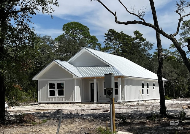 view of front of property featuring board and batten siding and metal roof