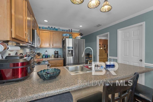 23530 Arbor Creek Dr, Robertsdale, AL 36567 - kitchen featuring a sink, stainless steel appliances, a kitchen breakfast bar, crown molding, and brown cabinetry