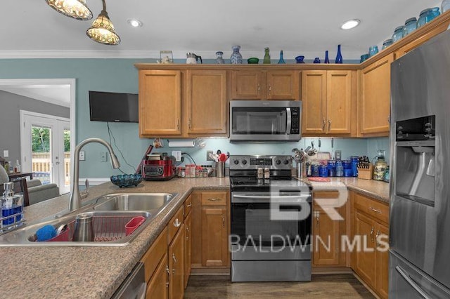 23530 Arbor Creek Dr, Robertsdale, AL 36567 - kitchen with appliances with stainless steel finishes, a sink, ornamental molding, brown cabinetry, and dark wood-style floors