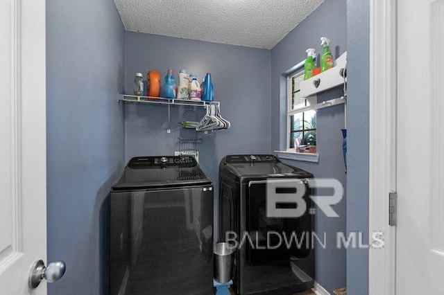 23530 Arbor Creek Dr, Robertsdale, AL 36567 - laundry room featuring washing machine and dryer and a textured ceiling