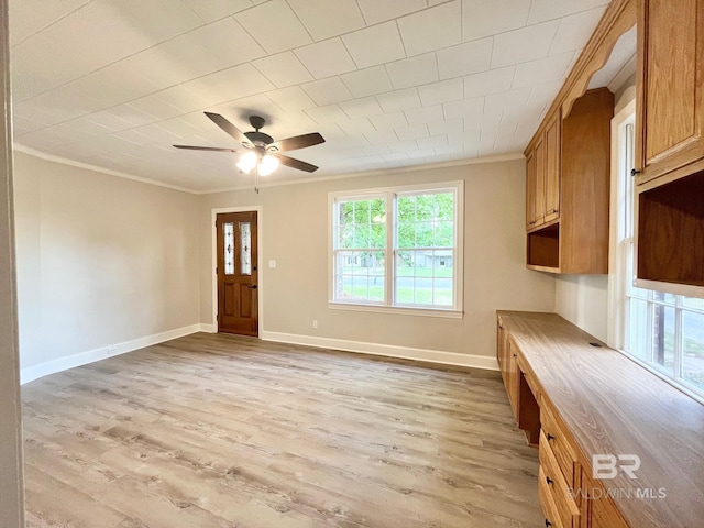 unfurnished living room featuring ceiling fan, baseboards, ornamental molding, and light wood-style flooring