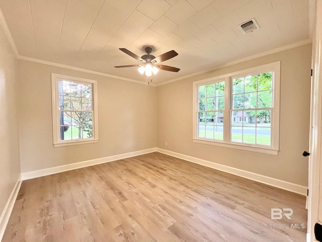 empty room with a ceiling fan, baseboards, ornamental molding, and wood finished floors