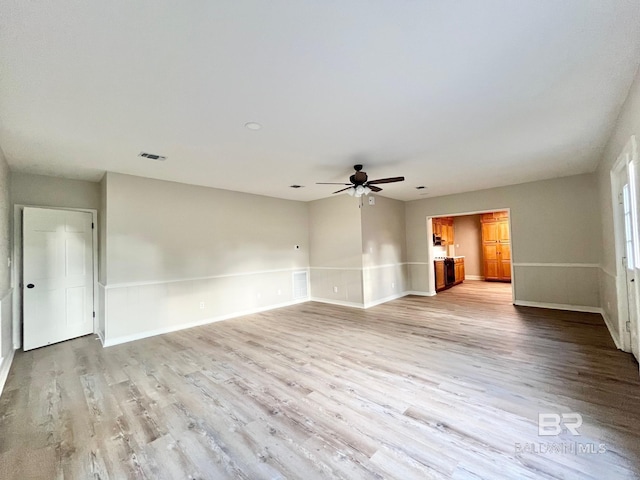unfurnished living room featuring baseboards, ceiling fan, light wood-type flooring, and visible vents