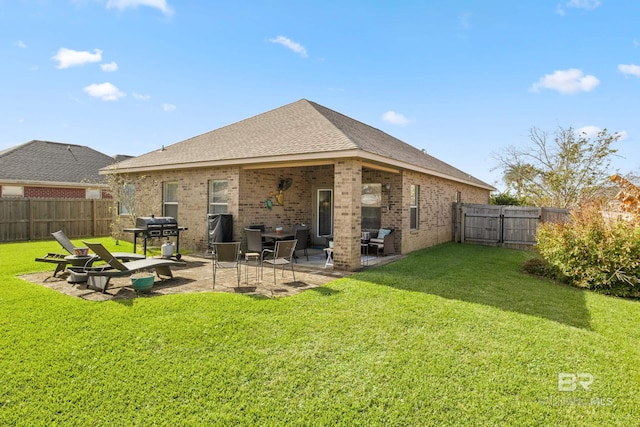 back of property featuring a lawn and a patio area